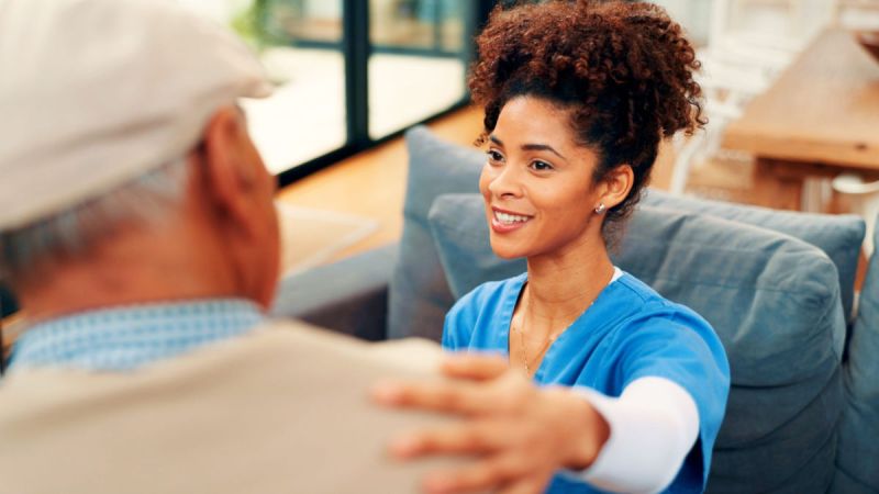 Caregiver with senior offering kindness and support.